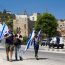 Illegal Israeli settlers waving flags follow Yuli Novak, previous chairwoman of Breaking The Silence | Photo by: Oren Rozen | Via: Wikimedia Commons | Licensed under: CC BY-SA 4