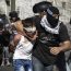 A Palestinian child dragged by his neck by an undercover Israeli militant | Photo via: Addameer.org